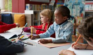 Un groupe d'enfants font du coloriage