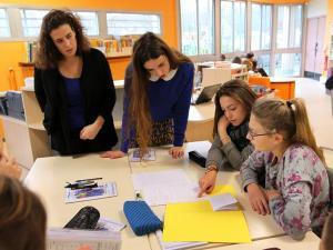 Des enseignants et des collégiens en groupe de travail en classe